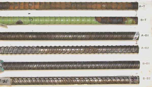 Figure 65. Slab #7 after autopsy. Photo. After autopsy, a top mat straight ECR (A-T) is completely delaminated due to extensive corrosion, and the second ECR(B-T) shows moderate coating delamination. The cleaned bottom mat four black bars look good without sign of corrosion.