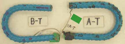 Figure 76. Slab #11 extracted rebars condition. Photo. Before autopsy, the top mat two bent ECRs (A-T and B-T) exhibit moderate coating deterioration.