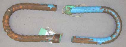 Figure 77. Slab #11 after autopsy. Photo. After autopsy, a top mat bent ECR (A-T) is completely delaminated while the other top mat bent ECR (B-T) is partially delaminated showing some substrate corrosion. 