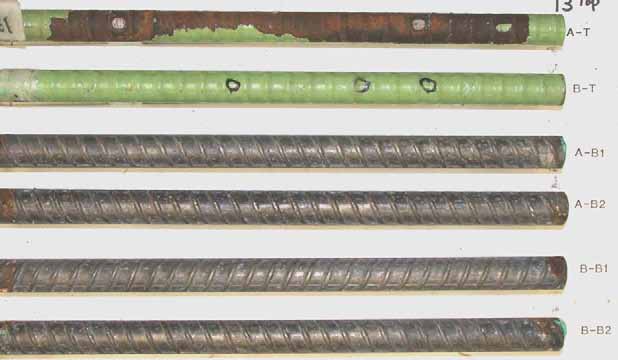 Figure 83. Slab #13 after autopsy. Photo. After autopsy, a top mat ECR (A-T) is significantly (more than 40 percent) delaminated and corroded substrate is revealed, while the other top mat ECR (B-T) remains the same. The cleaned bottom mat four black bars look good.