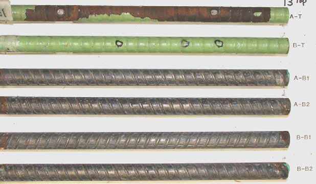 Figure 83. Slab #13 after autopsy. Photo. After autopsy, a top mat ECR (A-T) is significantly (more than 40 percent) delaminated and corroded substrate is revealed, while the other top mat ECR (B-T) remains the same. The cleaned bottom mat four black bars look good.