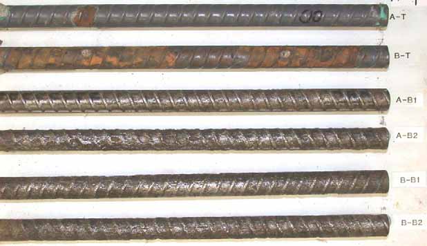 Figure 86. Slab #14 after autopsy. Photo. After autopsy, while a top mate ECR (A-T) exhibits minor corrosion with small coating disbondment, the other top mat ECR (B-T) suffers extensive coating deterioration and substrate corrosion. Most of the cleaned four bottom mat black bars exhibit severe corrosion damage. 