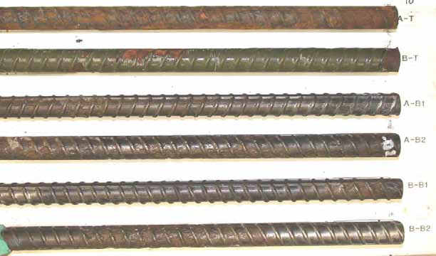 Figure 98. Slab #18 after autopsy. Photo. After autopsy, a top mat ECR (A-T) is completely delaminated and corroded, while the other top mat ECR (B-T) exhibits limited delamination with some substrate corrosion. The cleaned bottom mat bars exhibit either moderate pitting corrosion (A-B2 and B-B2) or no corrosion (A-B1 and B-B1). 