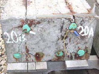 Figure 102. Slab #20 front, rear, and top views with specifications. Photos. (A) Slab number 20 front view shows the 20B label on the left and 20A on the right. All bars show corrosion with bleeding and cracks in the concrete. Wires connect the top and bottom bars of 20B; the same is true for 20A. 