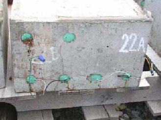 Figure 108. Slab #22 front, rear, and top views with specifications. Photos. (A) Slab number 22 front view shows the 22B label on the left and 22A on the right. The top left bar shows corrosion, and a major crack runs from the top right bar to the second lower bar with minor staining on the concrete. Wires connect the top left and bottom bars of 22B and just the lower bars for 22A. 