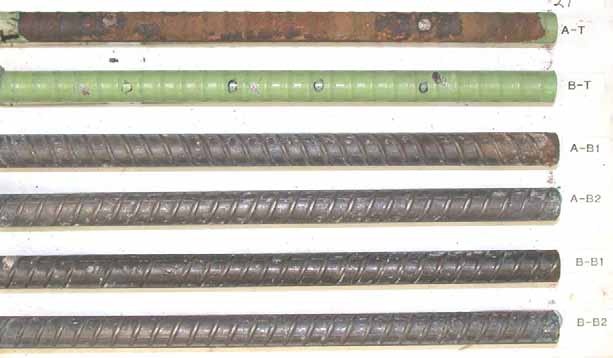 Figure 116. Slab #24 after autopsy. Photo. After autopsy, a top mat ECR (A-T) is completely delaminated and reveals corroded substrate. The other top mat ECR (B-T) remains unchanged. The cleaned bottom mat four black bars are shiny with minor pitting.