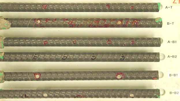 Figure 130. Slab #29 extracted rebars condition. Photo. Before autopsy, a top mat straight ECR (B-T) shows moderate coating degradation and all the other straight ECRs show good condition except for intentional coating defects. 