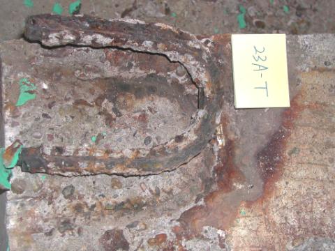 Figure 35. Typical condition of bent black bars in the top mat (slab #23-top right bar). Photo. The picture shows an extracted bent black bar labeled 23A-T from the top map. It is severely corroded.