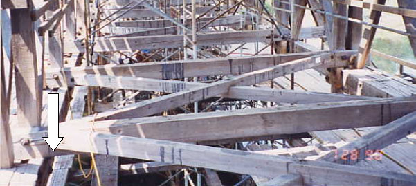 Some floors contain a bottom lateral system with members that meet at midspan or at the end of the floor beam that can reduce the strength of the floor beam. The picture shows a bridge under rehabilitation with the cross bracing of the floor beams and a mortise-and-tenon connection of laterals at the sides of the bridge.