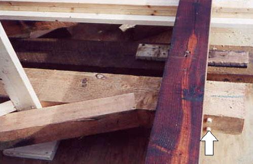 To solve the increased shear stresses in notched timbers, hardwood timber dowels are used because they are less expensive and don't rust like lag screws. The picture shows the dowel reinforcing a post against a horizontal shear from the vertical component of the load in the diagonal.