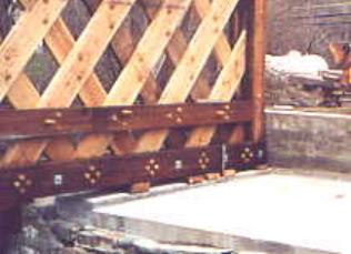 The picture shows bearing blocks beneath the chord members directly below the lattice intersections above the bearing area. The bearing blocks are full width, supporting all six planes of the truss components.