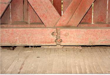 The picture shows a huge joint opening in the bottom chord of a Town lattice truss with the butt ends pulled away from the pegs, perhaps because the joint is at the intersection of the lattices instead of midway between the lattice intersections.