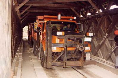 This picture shows two trucks of known loads inside the bridge to test for actual deflection measurements.