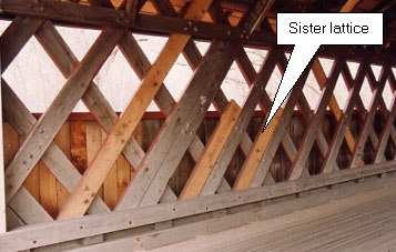 The web elements of Town lattice trusses often become split at their bottoms. The picture shows a repair where the entire element is not replaced, but three sister lattices (about half the height of the original) are installed next to the damaged elements.