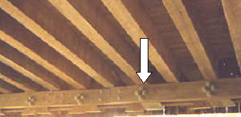 The picture shows steel bolts instead of wooden pegs in a Town lattice bottom chord replacement. Bolts tend to be stiffer than the timbers they connect to and the bolt holes are not accurate so that the load is not shared evenly which can cause dramatic failures or progressive collapse.
