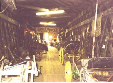 Some historic bridges have been converted for unusual uses after serving their useful life for vehicular traffic. The picture shows the interior of a bridge that has been converted to a museum. The displays are old carriages, farm implements and signs.