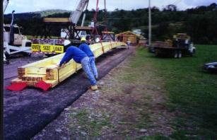 Figure 181 A one-hundred-thirty-foot- (39.6 meter) long one-piece bottom chords - monsters to fabricate and deliver and a hand-full to work with. The beam seems to be suspended by slings and is lying flat on iats side.Photo.