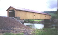 Figure 186 Near final exterior view of the rehabilitated Hamden Covered Bridge. Guide rail not yet installed and final seeding and mulch also not in place yet. Photo.