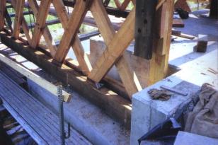 The abutments were judged sound so a portion of each corner was removed to allow installation of a longer truss. The picture shows the longer trusses inserted into the new recess in the existing abutment.