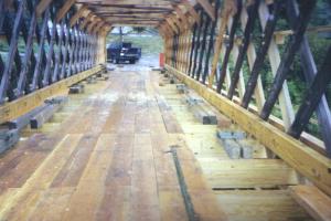 The interior shot shows the nearly completed decking, which is conventional 102-millimeter by 305-millimeter (4-inch by 12-inch) Douglas fir planking. Sacrificial 51-millimeter (2-inch)-thick running planks were installed later on top of the primary floor.