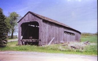 The repairs started in 1987, but were not completed. So the bridge sat on cribbing and suffered differential settling and racking. The wood shingle roof was leaking.