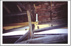 The challenge of this rehabilitation was to replace truss components with minimal removals. The top chord of the east truss was built in three pieces and positioned onto tenons from the ends of the posts. The lighter timbers in the picture are replacement members.