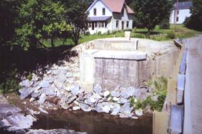 The picture shows the new thick concrete pads cast on top of the abutment to knit the original stone and concrete facing together. The backwalls and short wing walls can also be seen in the photo.