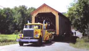 The picture shows one of two large wreckers with a winch used to haul and position the Brown's Rover Bridge.