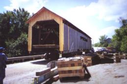 The picture shows the bypass bridge that allowed the covered bridge on dollies to be steered, then aligned on its abutments.