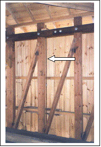 The picture shows the vertical reinforcement rod inserted next to the post after an overweight vehicle caused shear failure in an unreinforced corbel. This accident indicated that reinforcement of more corbels than required by the design vehicle would have been a cost-effective measure.