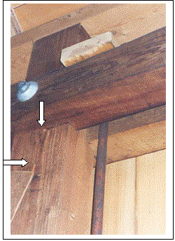 This picture shows the closeup of the rod connection with dtwo whnte arrows indicating the vertical misalignment along the slip plane. This repair was more difficult once the bridge was reinstalled over the water and the siding was in place.