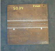 The photo shows the plan view of laboratory specimen S034 with the weld oriented horizontally. The left and right sides of the specimen are labeled A and B, respectively.