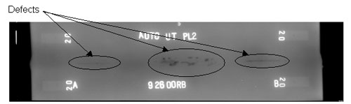 The radiographic image shows three longitudinal discontinuities along the weld length. The discontinuities are circled for illustrative purposes.