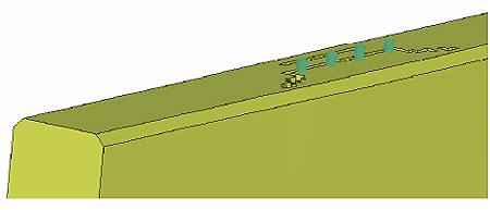 Figure 116. Illustration. Parapet failure with fracture energies at 50 percent of baseline values. This is a closeup view of the top center and field side of the parapet. The erosion pattern is confined to the top of the parapet. Two horizontal rows of erosion are evident, and extend the width of the baseplate (which has been removed for better viewing). At each end of the central row, an at-angle line of erosion extends to the field edge of the parapet and stops.