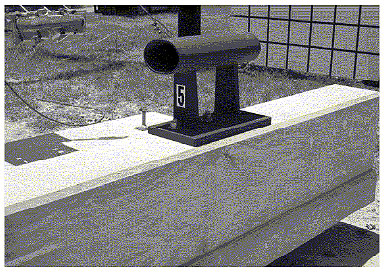 Figure 90. Photo. Parapet damage after test P5, rear</strong>. This post-test view is a rear view, and also reveals no damage or deflection, except for perhaps one hairline crack.