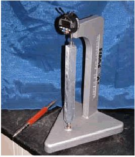 This photo shows the length comparator device with an ASR mortar bar being measured.