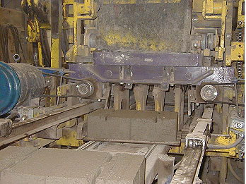 Figure 11. Photo. Demolding of SRW units during production. Picture of SRW blocks rolling from compacting machine at block plant.