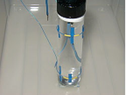 Figure 114. Photo. Water-filled unconfined vial. Picture shows a vial with thermocouples attached.