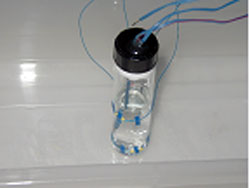 Figure 116. Photo. Water half-filled unconfined vial.