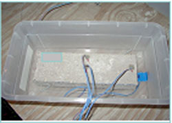 Figure 127. Photo. Container holding an SRW block with thermocouples attached.