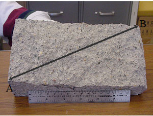 Figure 50. Photos. Section through region containing split face delamination. Photo b shows a larger view of the removed section A and B from photo a.