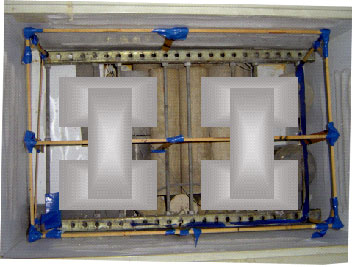 Figure 75. Photo. View of chest freezer with wooden frame and six specimens.