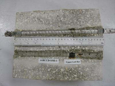 Figure 94. Photo. Top L bar and bar trace of specimen 4-BCCD-SMI-1 subsequent to dissection. This is a photograph of a top L bar and bar trace of specimen 4-BCCD-SMI-1 subsequent to dissection. Corrosion is apparent at clad defects.