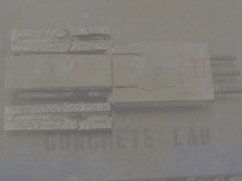 Figure 115. Photo. Specimen 3BTC-STD2-2101-C after sectioning and opening along the two longer bars. This is a photograph of specimen 3BTC-STD2-2101-C after sectioning and opening along the two longer bars. Corrosion is apparent on both long bars.