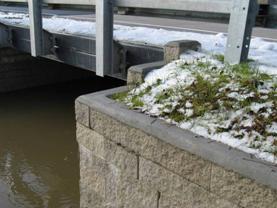 This photo illustrates the wet-cast concrete coping details used to the form the cap of the geosynthetic reinforced soil (GRS) abutment walls. The type of coping finish used is rounded.