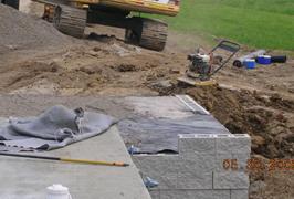 This photo illustrates how the beams ends are embedded into the geosynthetic reinforced soil (GRS) abutment. The photo shows the parapet wing walls up against the side of the beams with several additional layers of GRS, depending on the thickness of the bridge girders.