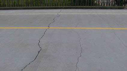 Photo. Transverse Crack on Top of the Bridge Deck in Span 3. Click here for more information.