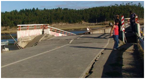 Photo. Buckling of pavement at north abutment of Tubul bridge. Click here for more information.