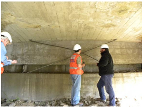 Photo. Damage to rebar X-brace system on north abutment of El Bar bridge. Click here for more information.