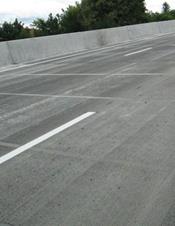 This photo shows a bridge deck reconstructed with precast concrete deck panels and field-cast ultra-high performance concrete connections. The deck surface has been profiled and opened to traffic.